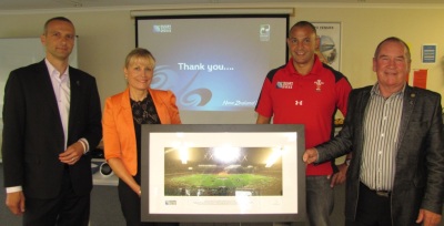 RNZ 2011 General Manager Andrew Steele, TDC's RWC 2011 Project Manager Karen Balasoglou, Deputy Mayor Mike Downard, and Mayor Rick Cooper holding the framed image of Eden Park.